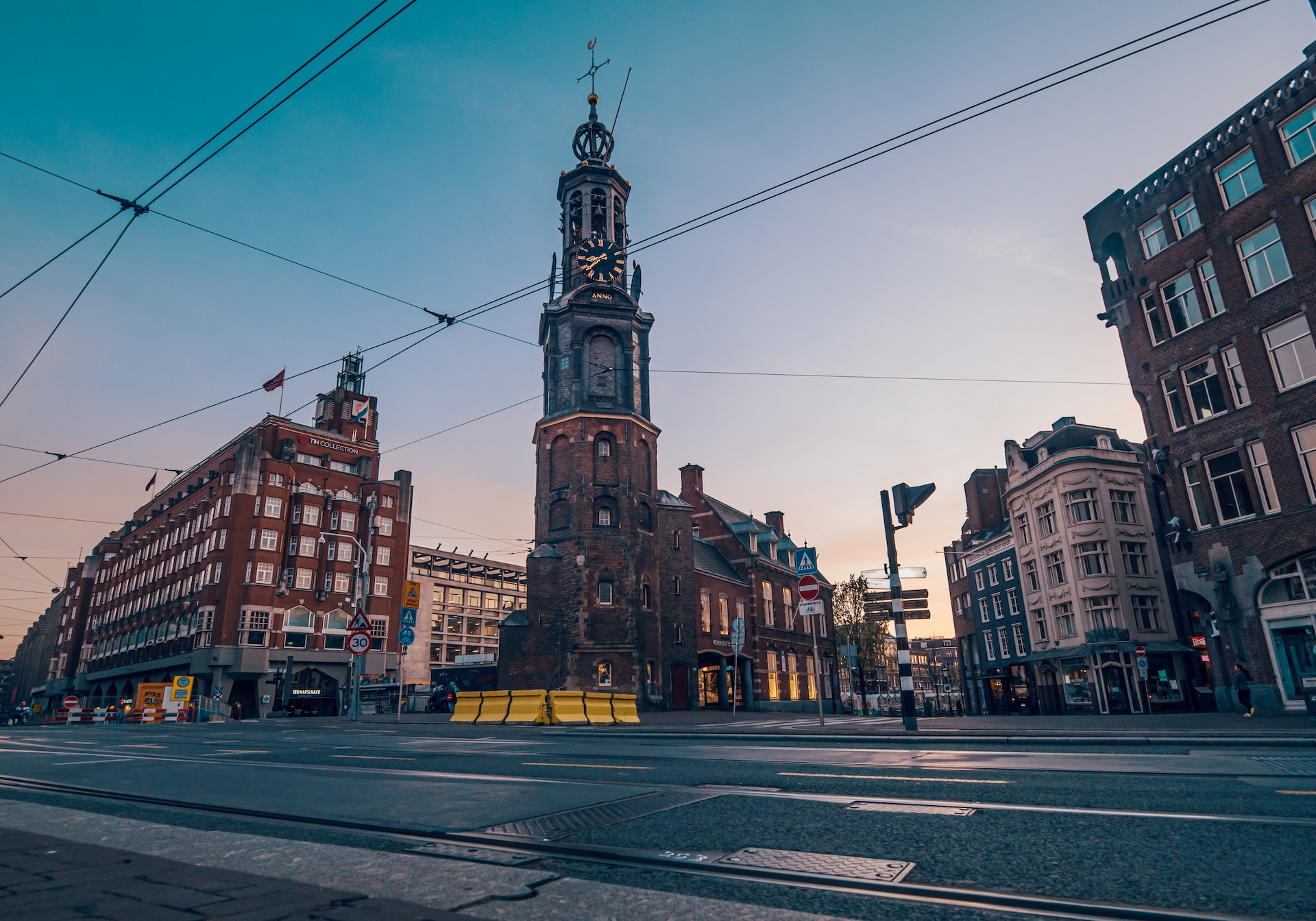 view of muntplein in Amsterdam, muntkerk and renovations at the street, blue sky 